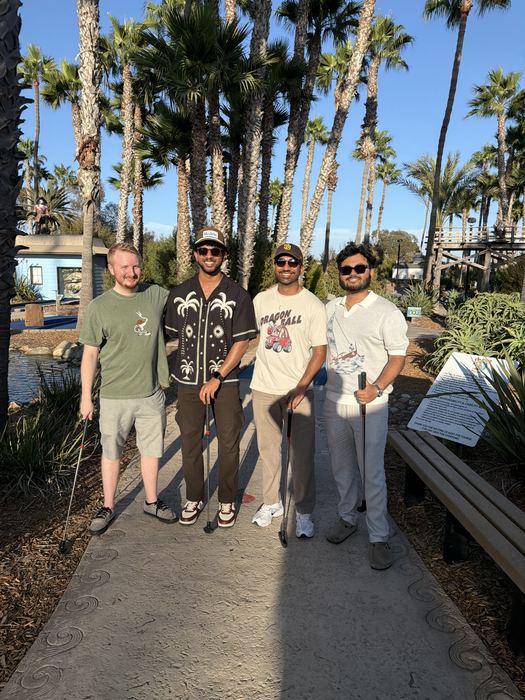 Naveen with three teammates from AskTuring at a mini golf course