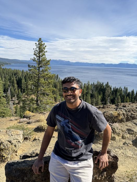 Naveen smiling at a lookout above Lake Tahoe